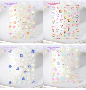 Detail of 5D embossed nail art stickers featuring tulips, daisies, and butterflies