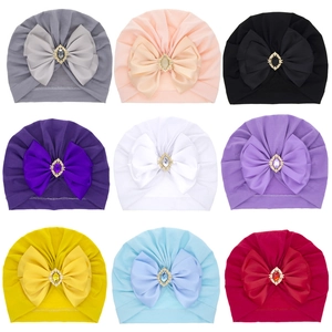 Baby turban hats set with large rhinestone bows in nine vibrant solid colors