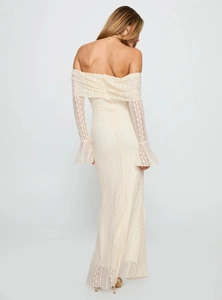 Detail view of the elegant lace texture and back silhouette of this off-shoulder ivory dress