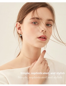 Close-up of elegant gold hoop earrings with sparkling moissanite on a model