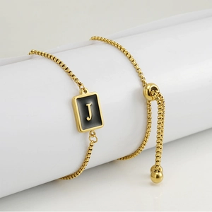 Detail of adjustable gold-plated stainless steel chain with square letter J pendant