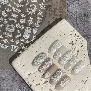 White baroque lace nail art stickers with embossed patterns for professional manicure design