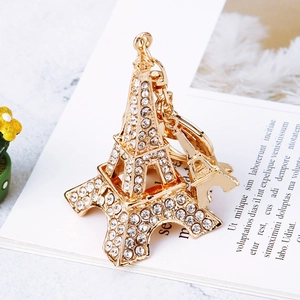 Macro shot of gold Eiffel Tower keychain with sparkling rhinestones and rotating clasp