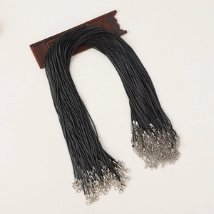 Macro detail of black wax cord necklaces with silver lobster clasps and extension chains