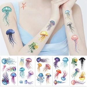 Detailed view of colorful jellyfish temporary tattoos with floral accents on skin and paper