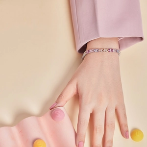 Detail of multi-color zircon tennis bracelet with S925 silver finish worn on female wrist