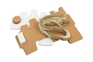 Flat lay of DIY kraft paper gift boxes with natural jute twine and blank gift tags