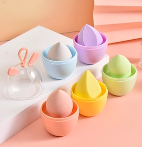 Detailed set of five colorful makeup sponges with storage bases and a rabbit-ear dust cover