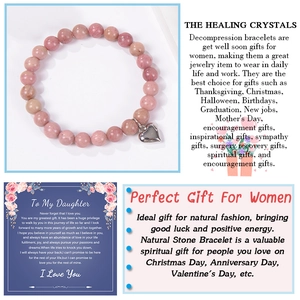Pink natural zebra stone beaded bracelet with silver heart charm on a greeting card