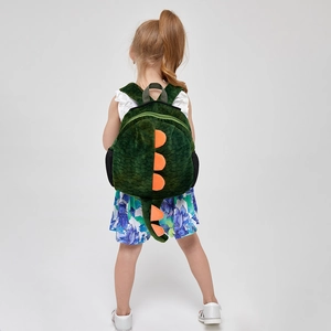 Detailed back view of a plush green dinosaur backpack with orange spikes on a child