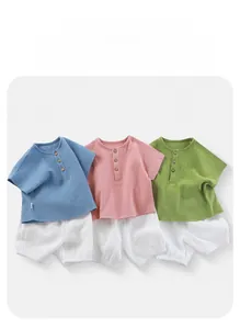 Close-up of breathable cotton gauze baby sets with vintage wooden buttons and texture