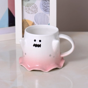 Close-up of cute ghost ceramic mug with white to pink gradient and star patterns