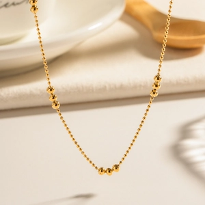 Polished 18K gold stainless steel beaded chain necklace with layered metallic spheres