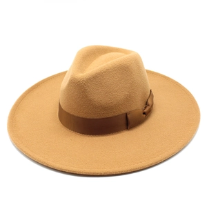 Detail of wide brim camel wool fedora hat featuring a brown grosgrain ribbon bow
