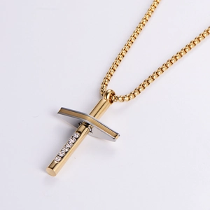 Iced-out gold and silver cross pendant necklace with rhinestones on a white background