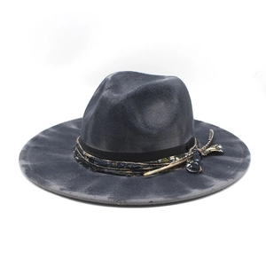 Detail of vintage wool fedora hat with bohemian woven band and feather accent
