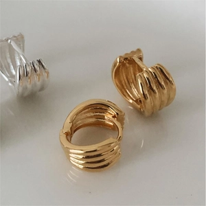 Detailed view of 925 sterling silver hoop earrings with multi-layer wavy texture finish
