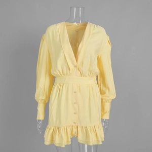 Detail of V-neckline with buttons and double-layered ruffle hem on yellow dress