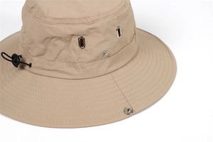 Detail of khaki sun hat with silver metal eyelets and adjustable elastic drawstring