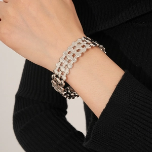 Close-up of a silver multi-layer layered hollow cuff bracelet worn on a female wrist