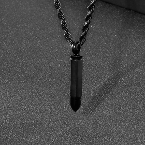 Detail shot of a black bullet pendant necklace with a stylish rope chain for men and women