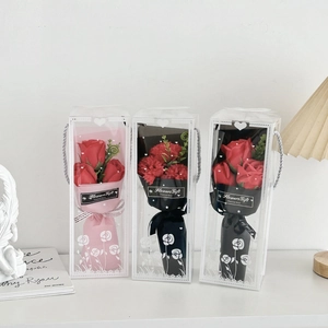 Three elegant gift boxes with artificial red roses and carnations for special occasions