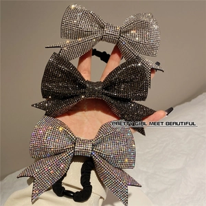 Sparkling rhinestone bow hair ties set with silver, black and iridescent crystals