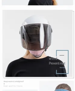Detail of pink fleece neck gaiter and white helmet with anti-fog goggles for winter riding