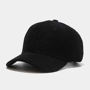 Detailed side view of high-quality black corduroy baseball cap with fine ribbed texture