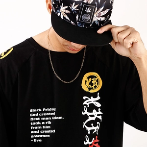 Detail view of Black Friday calligraphy print on black t-shirt and graphic baseball cap