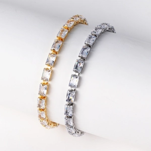 Detail of elegant gold and silver tennis bracelets with rectangular cubic zirconia stones