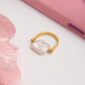 Detailed close-up of a square baroque pearl ring with elegant 18K gold plated finish