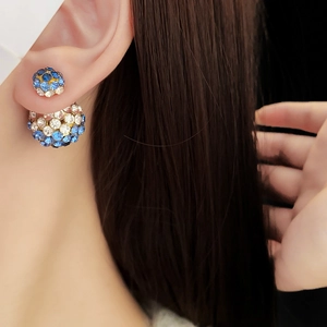 Nahaufnahme der Doppel-Ohrstecker mit blau-weißen Strasssteinen am Ohr des Models