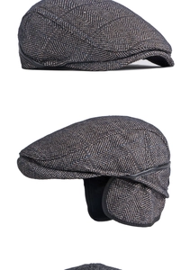 Dettaglio cappello piatto a spina di pesce con paraorecchie pieghevoli in grigio e marrone