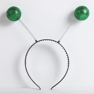 Detail of green glitter antennas on a black headband for alien costume party cosplay