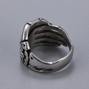 Detailed macro view of retro punk skull hand ring in vintage stainless steel finish