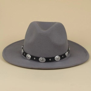 Detail of silver rivets and engraved buckles on a grey wool felt western jazz hat