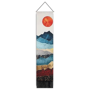 Vertical wall tapestry detail showing sun mountain landscape print with fringe and wooden rod