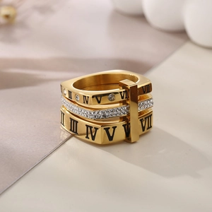 Close-up of golden tiered Roman numeral ring with sparkling white rhinestone accents