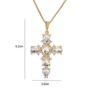 Detail shot of gold-plated cross pendant with dimensions of 6.2cm height and 3.6cm width