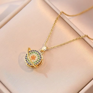 Golden planet pendant necklace with colorful cubic zirconia set in a beige silk gift box