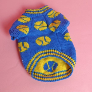 Detail of blue pet knit sweater featuring yellow tennis patterns and ribbed textures