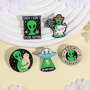 5-piece alien enamel pin set featuring UFO, cow, and cat designs on display