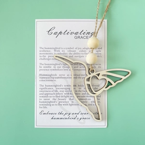 Detail of wooden hummingbird pendant with hemp rope and meaningful message card