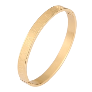 Detailed close-up of gold stainless steel bangle with engraved Roman numerals