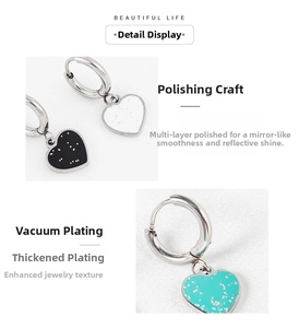 Detailed macro view of heart-shaped earrings with glitter finish and polished silver hoops