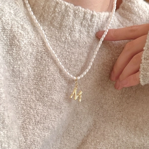 French vintage rice pearl necklace with a golden letter M pendant on a 925 silver chain
