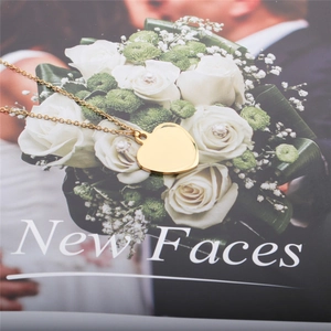 Detailed close-up of golden heart pendant necklace resting on a stylish magazine