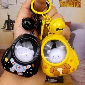 Detail of creative astronaut and bear acrylic keychains with 3D figures and tiny bells