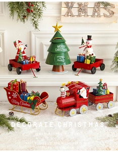 Macro detail of red metal Christmas train and sleigh ornaments with festive decor